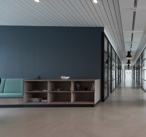 Empty modern office with desks, chairs, and tall windows