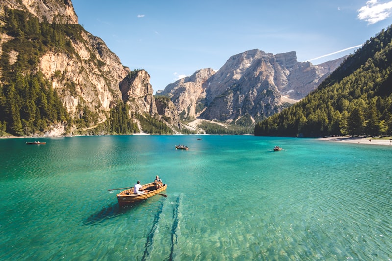 Alpine lake with forested mountains under soft daylight